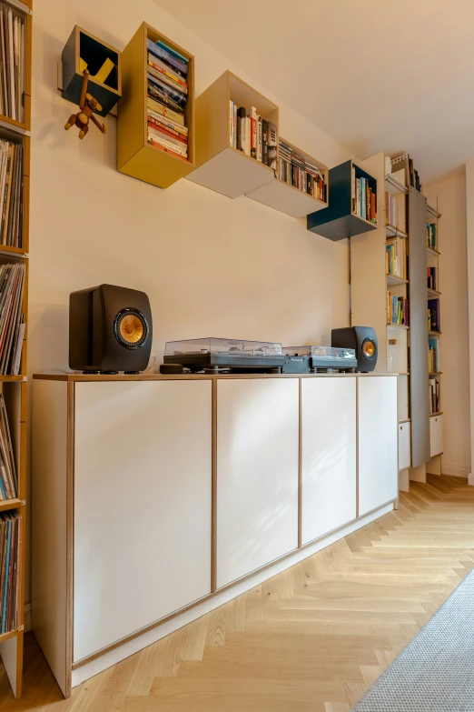 an audio system on top of a dresser next to record records