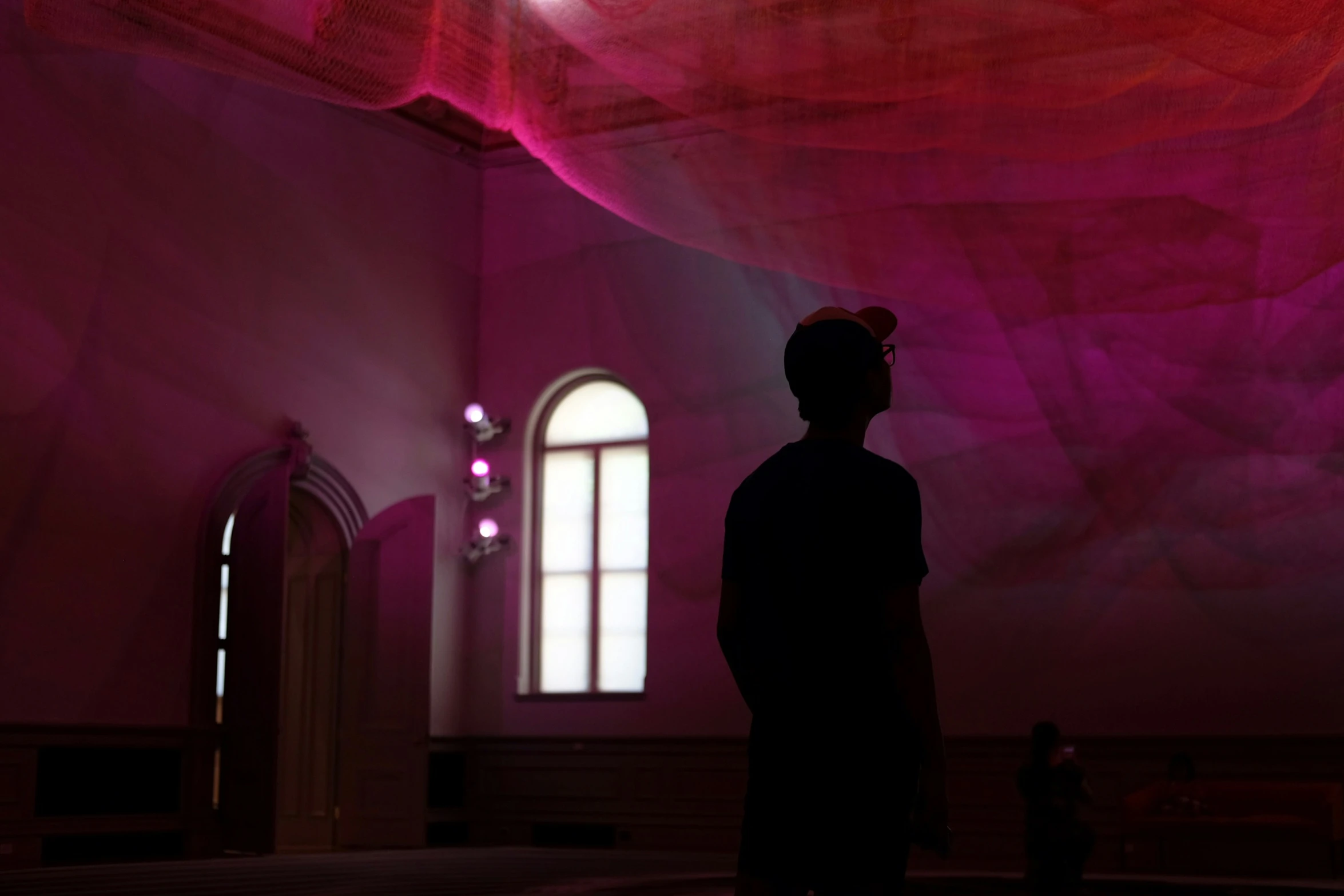 a person in a large room with purple walls and ceiling