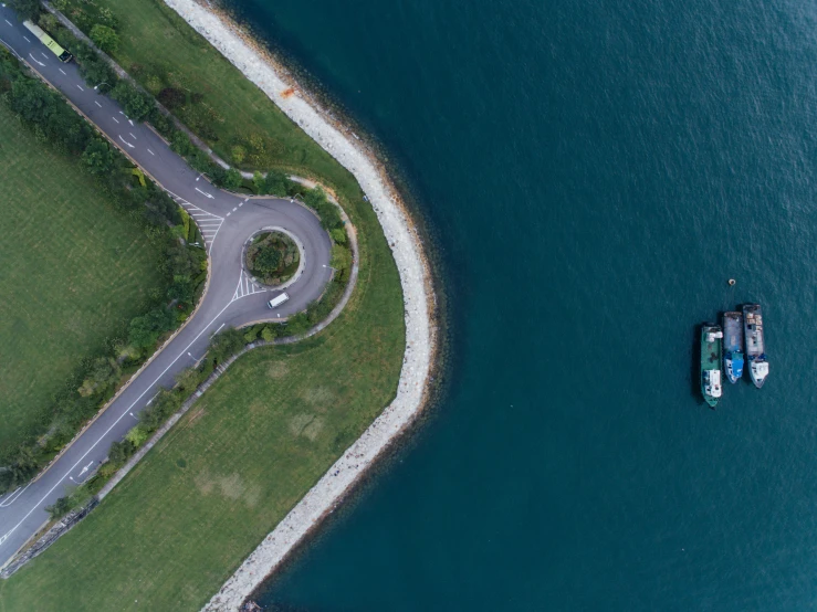 an aerial view of the lake and road