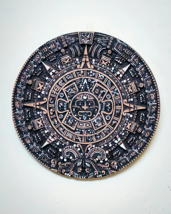 a black and copper decorative item on a white surface