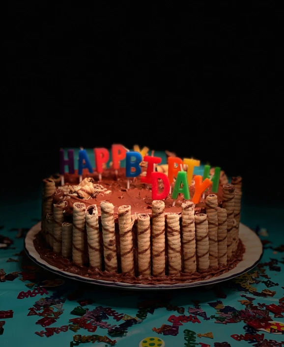 a happy birthday cake is decorated with wine corks