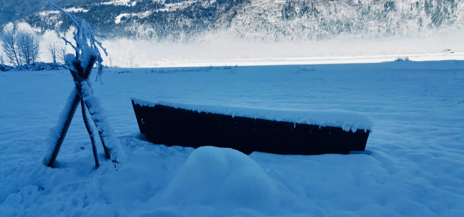 there is a small boat buried in snow