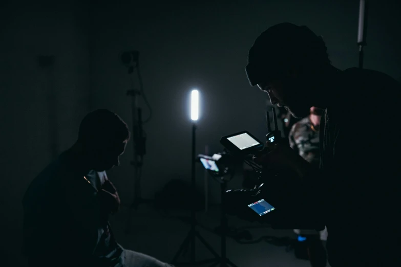 two people in the dark looking at their cell phones