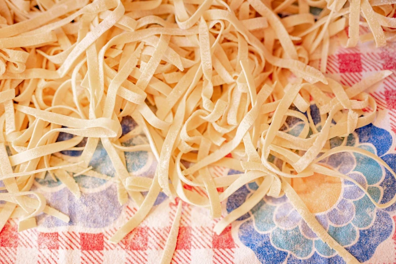 pasta, a few milled, on a plaid table cloth