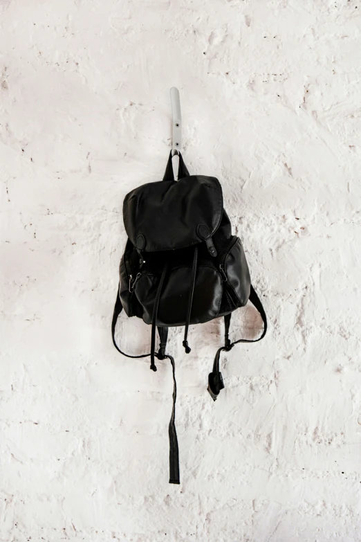 a black bag with white straps and some water