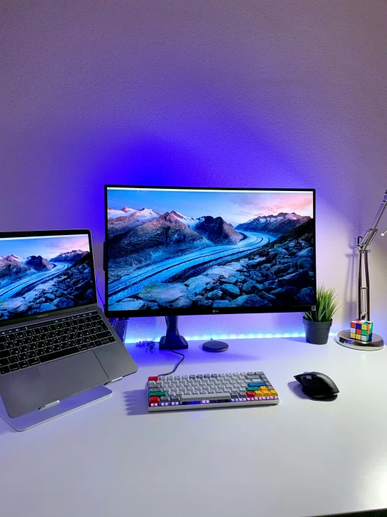 a desk with a laptop and two monitors