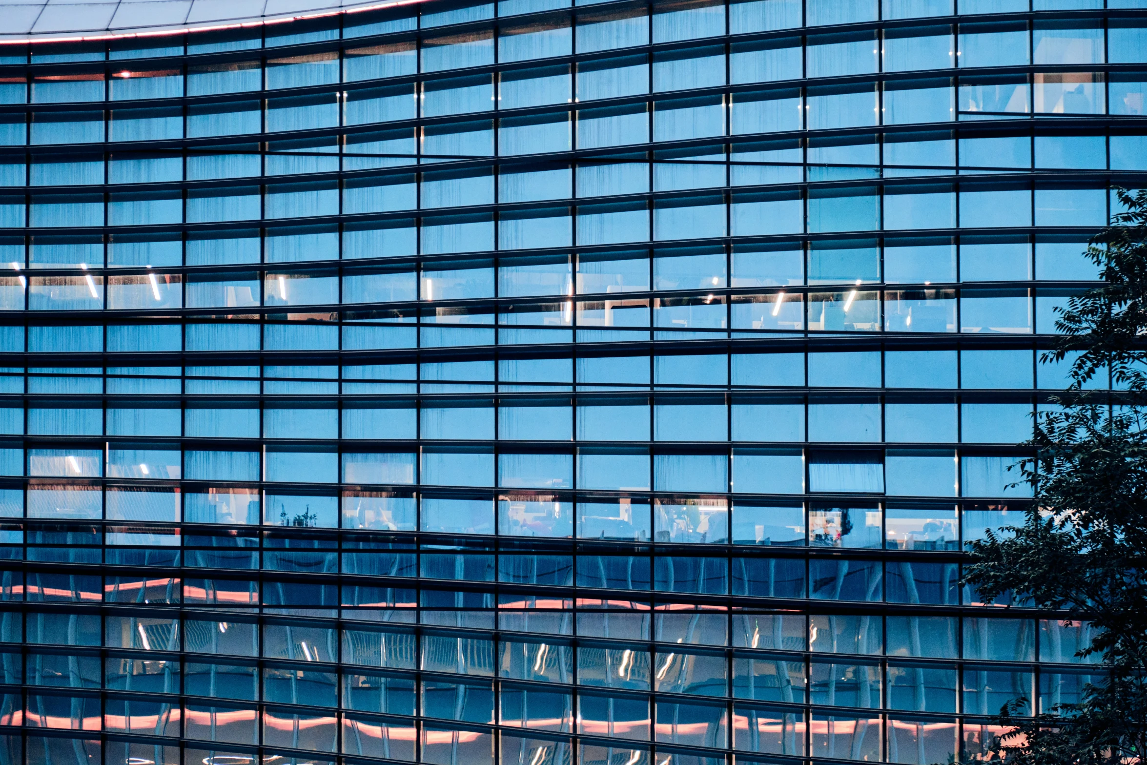 the building has many windows and reflection in it