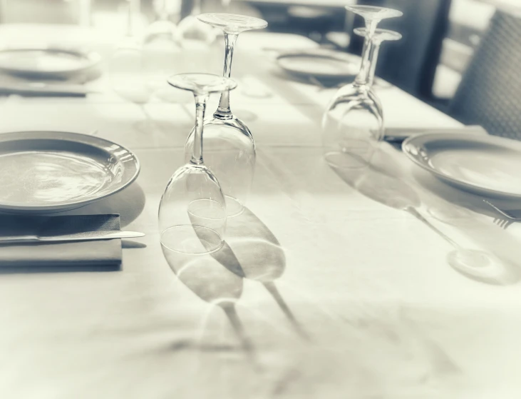 a table with place settings and plates set for eight