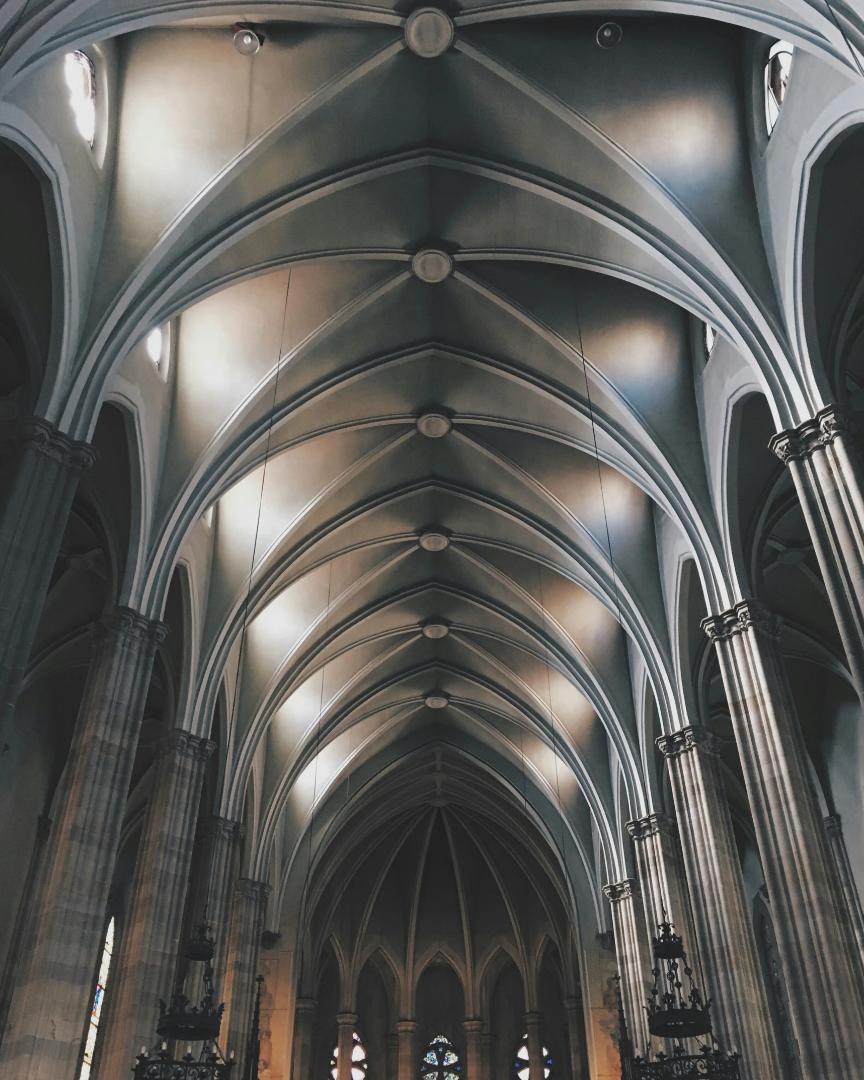 a church with multiple pillars and lit lights