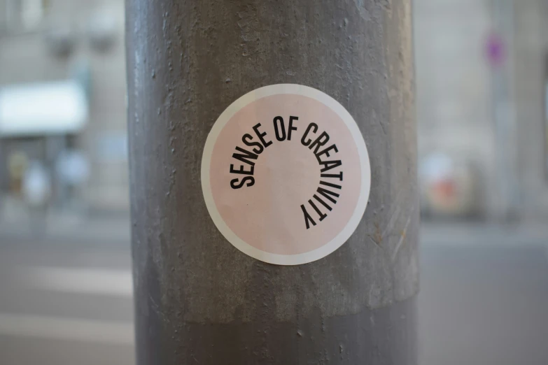 a black pole with a white sticker that says sense of certain kind