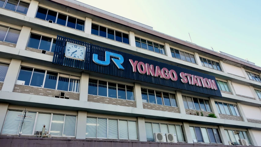 a building with many windows and a clock on the outside