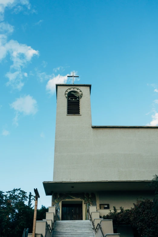 a large white building with a steeple and a clock on it