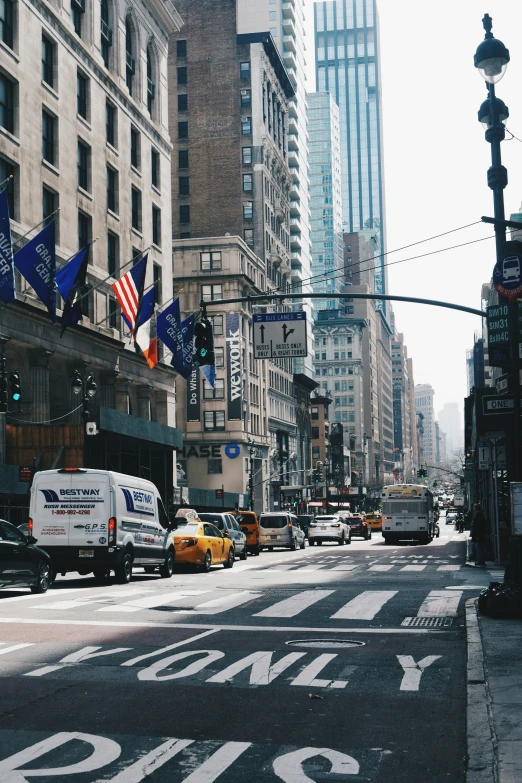 a city street with cars, buses and traffic lights