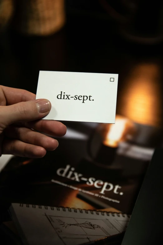 a person holding an object with the word dispt