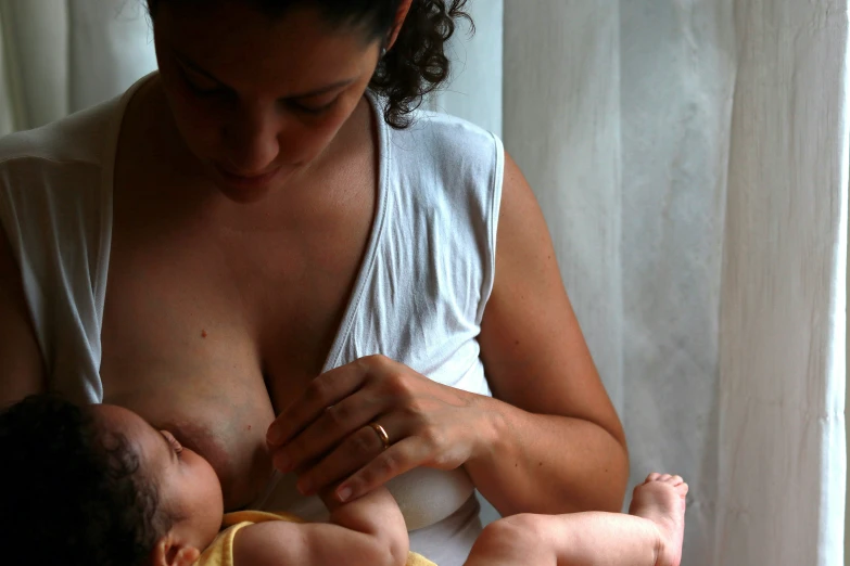 a woman holding a baby with her 