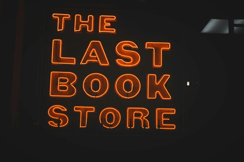 a neon sign reading the last book store
