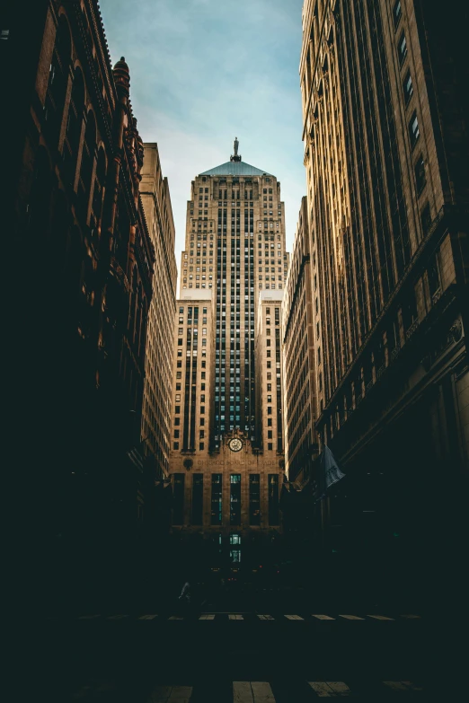 a big building standing behind another building with tall buildings