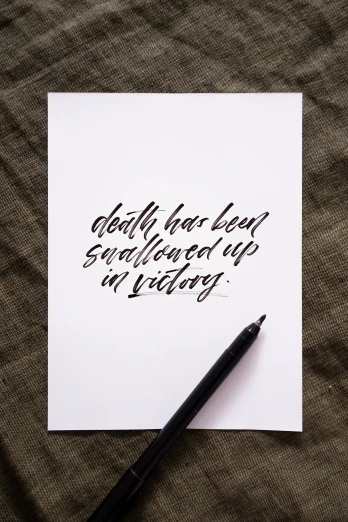 a calligraphy pen and a piece of paper
