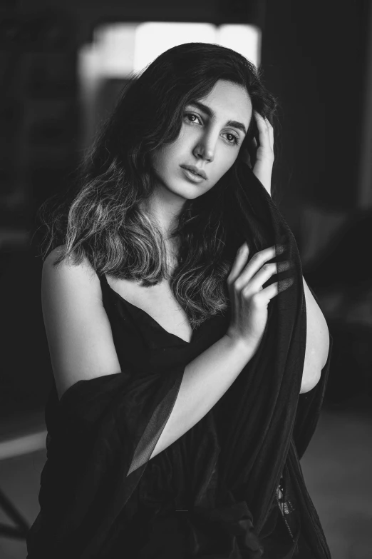 woman with long hair holding a scar while sitting down