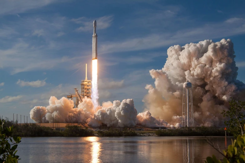 a rocket lifts off with smoke pouring out