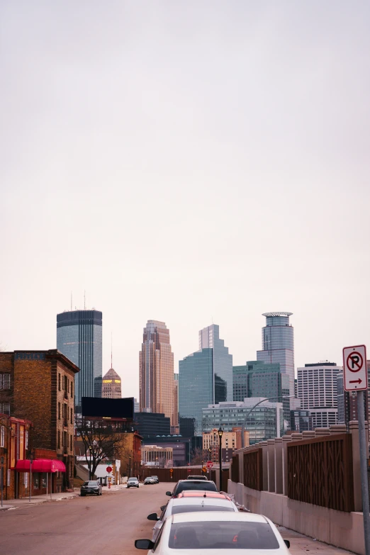 a city street with traffic and tall buildings in the background