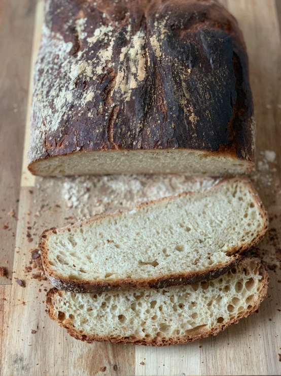 loafs of sour sour bread sitting on top of a  board