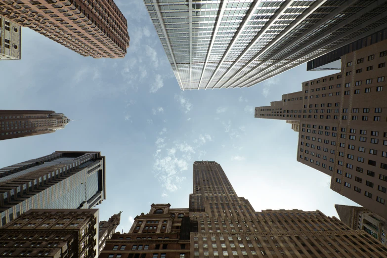 a very tall group of buildings are seen from below