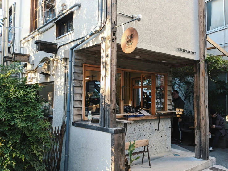 two people standing outside of a business in an old building