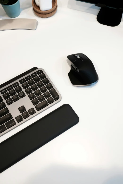 an image of a keyboard and mouse on a white desk