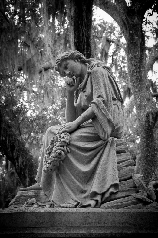 a statue that is sitting on top of a tree stump