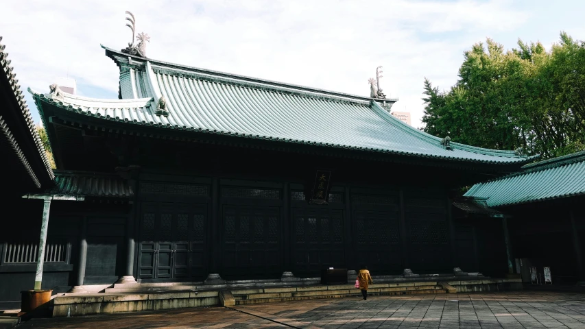 an asian building sits near the trees