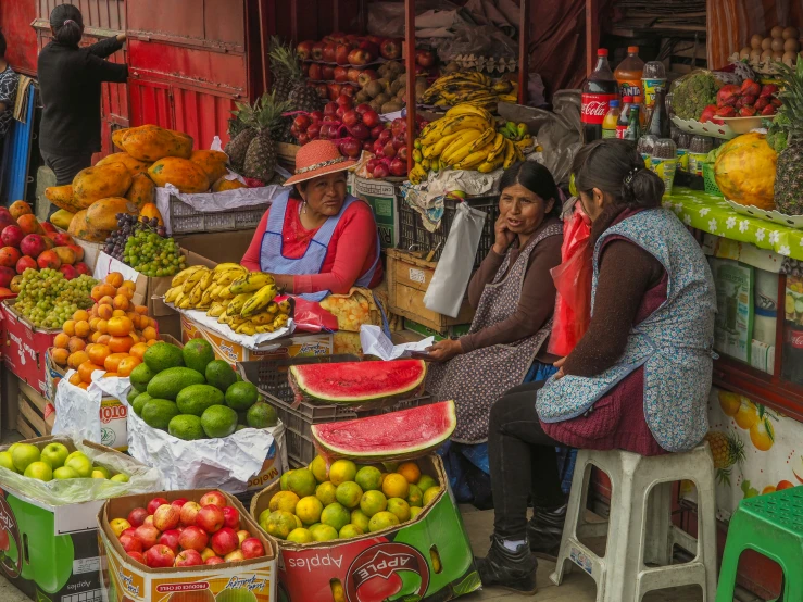 a market with fruit, oranges and other vegetables on display