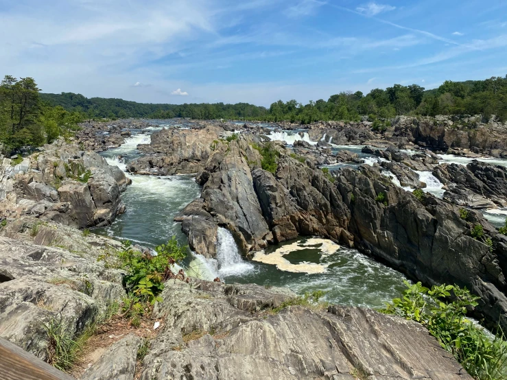 waterfall coming out from a river with rocks below