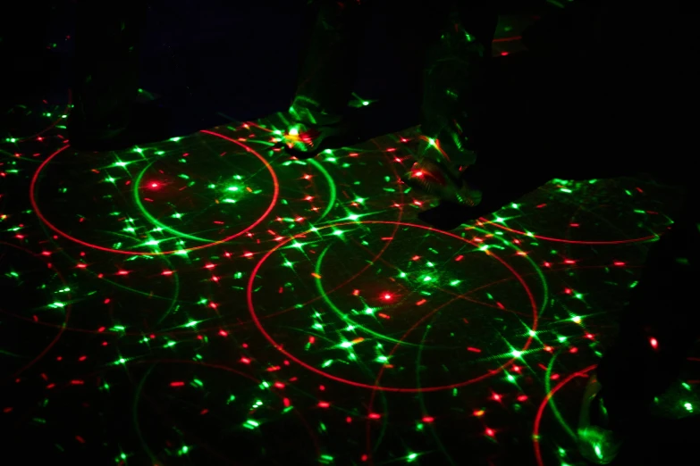 many circles on a black background are decorated with colorful lights