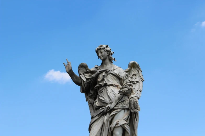 a statue is standing with its wings outstretched