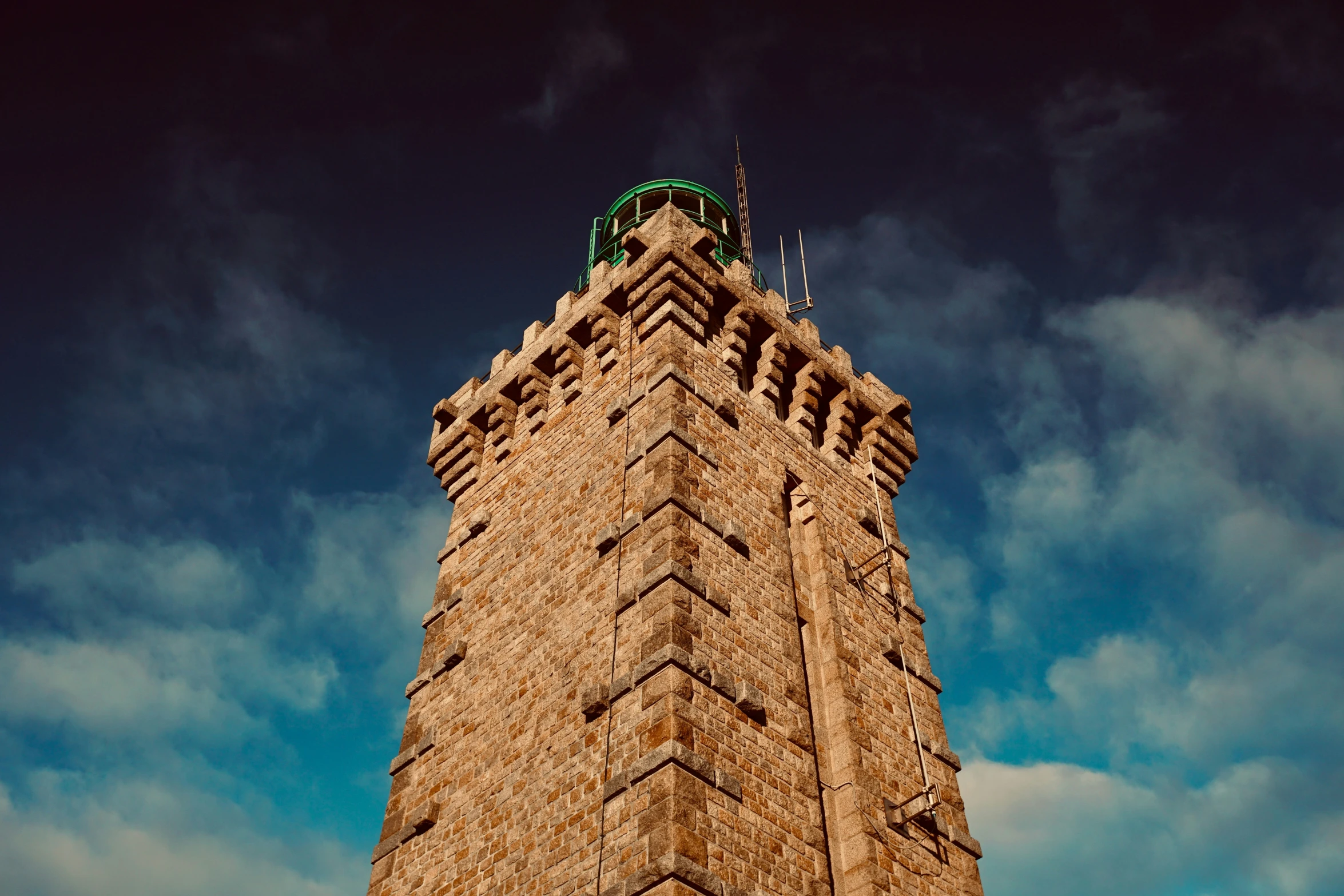 a very tall tower with a flag flying