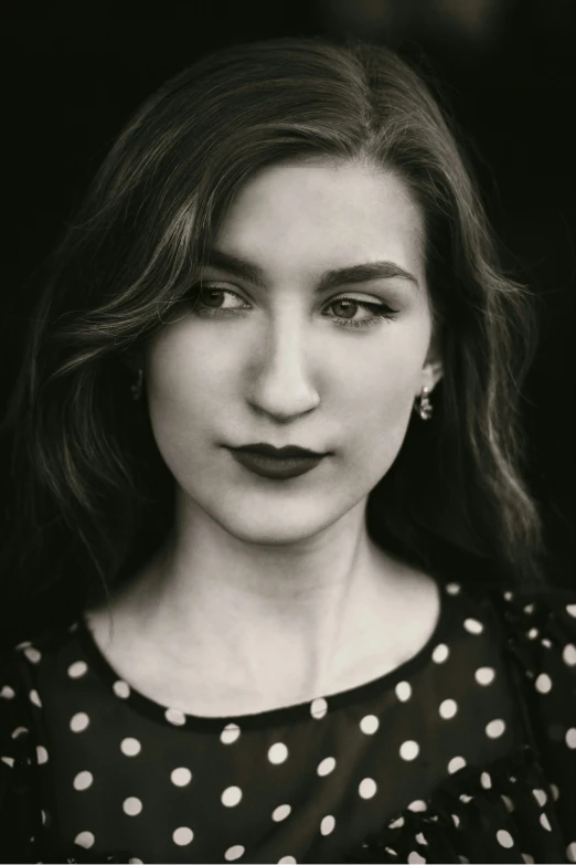 a young woman with long black lips poses for the camera