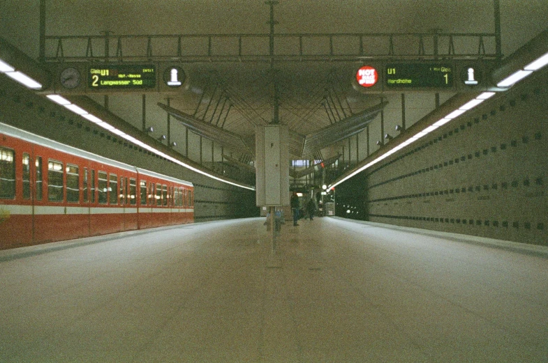 a subway station with three trains parked at gates