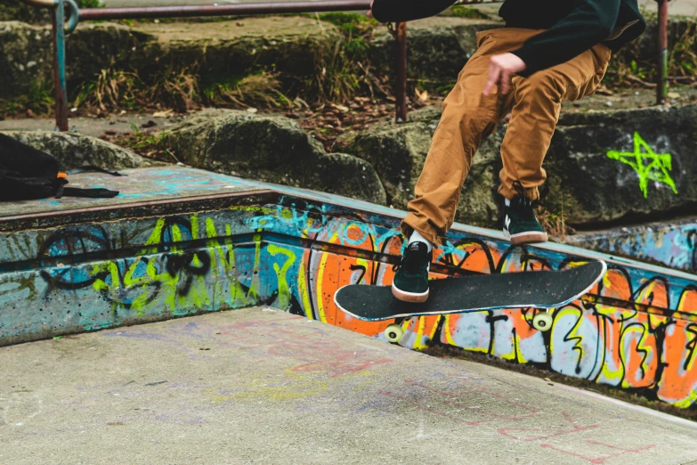 a young man performs a trick on his skateboard