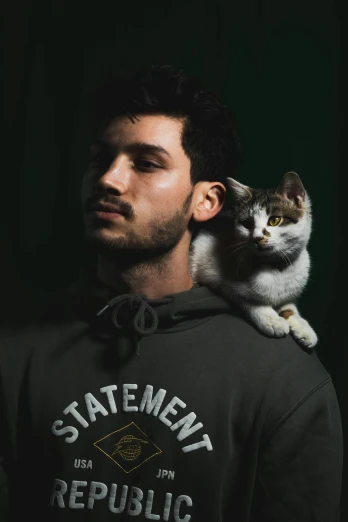 a cat is perched on top of a man