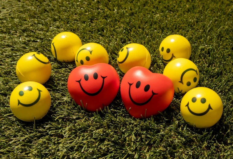 group of hearts and yellow balls with smiley faces