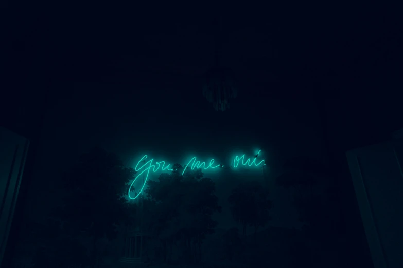 a lit up neon sign reads you are here