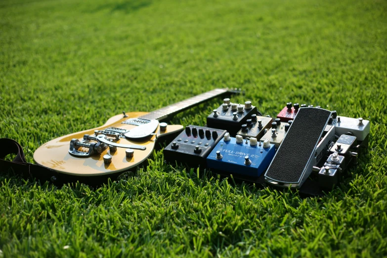 an electric guitar laying in the grass