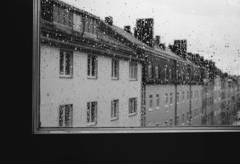 rain falling off the window into a cityscape