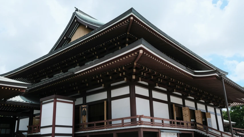 the front facade of a japanese structure with white trim