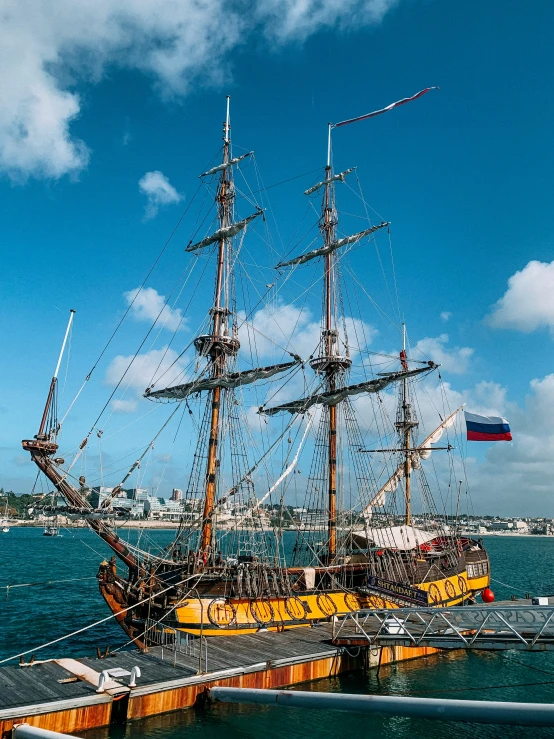 a large ship docked at a pier in the ocean