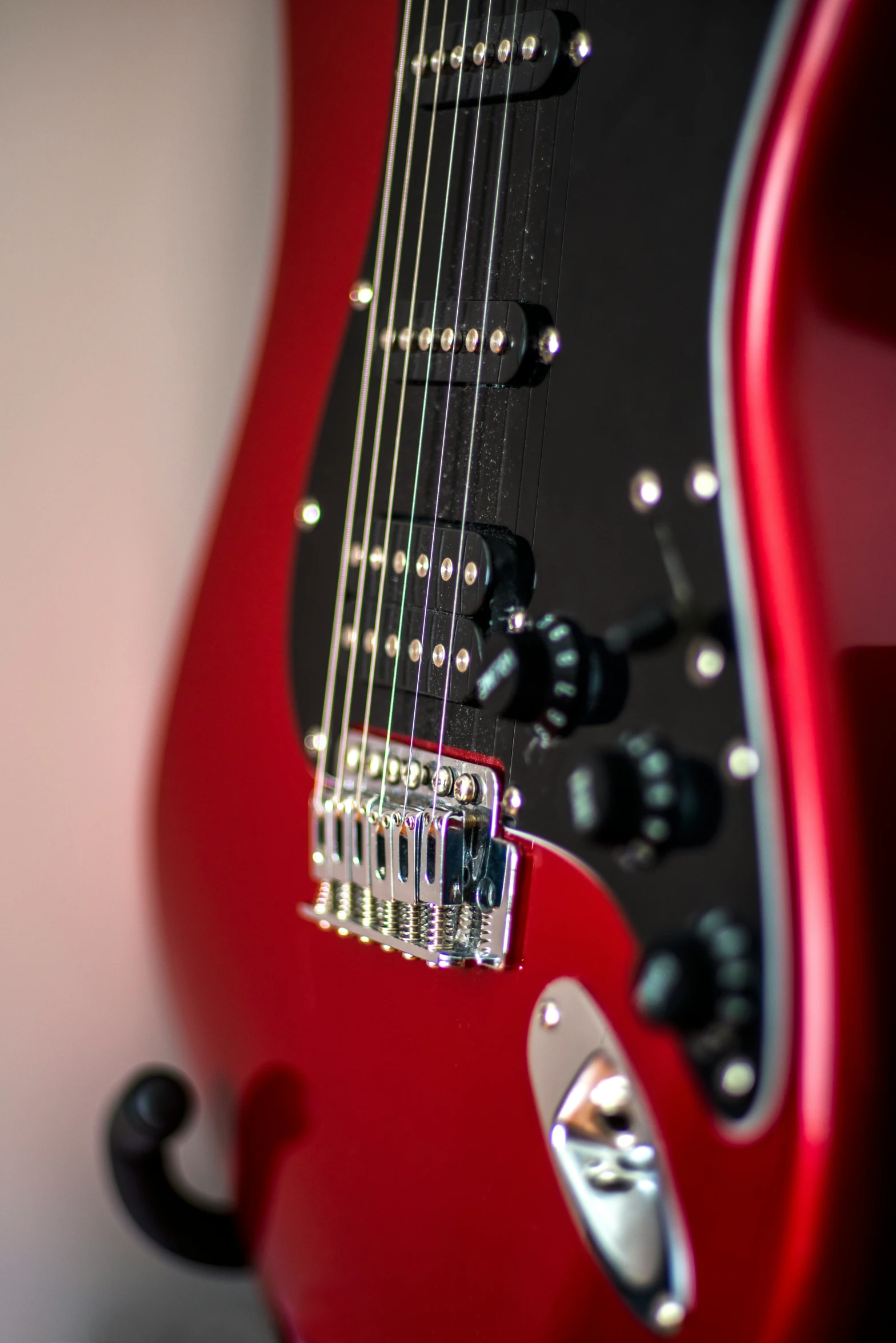 an electric guitar with black and red parts on it