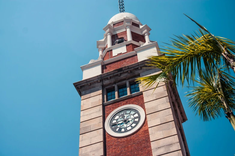 a clock tower with a large statue on the top of it