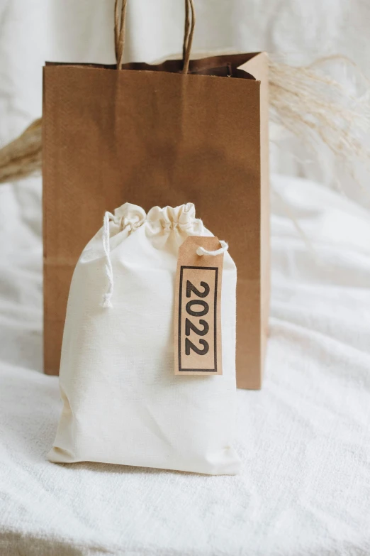 a white bag next to a brown paper bag with the number 2009 on it