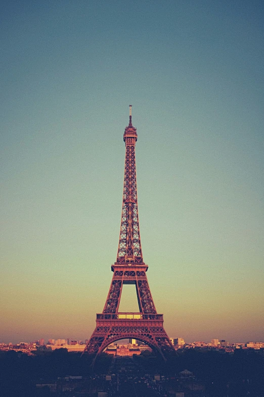 a tall metal tower towering over a city